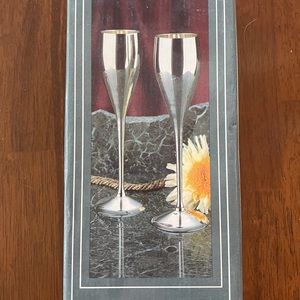 Two champagne flutes.  Silver plate.